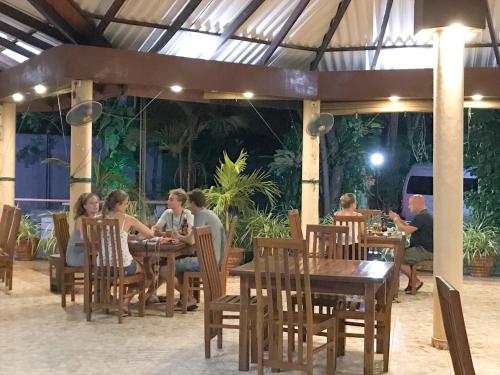 a group of people sitting at tables in a restaurant at Anon Rest in Dambulla