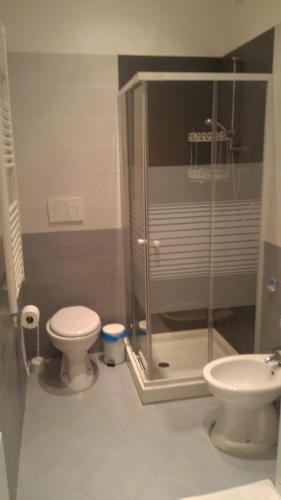 a bathroom with a toilet and a glass shower at InBlu in Bari