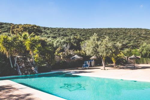 a swimming pool with a mountain in the background at Casas Rurales Cortijo la Cañada in Estepa