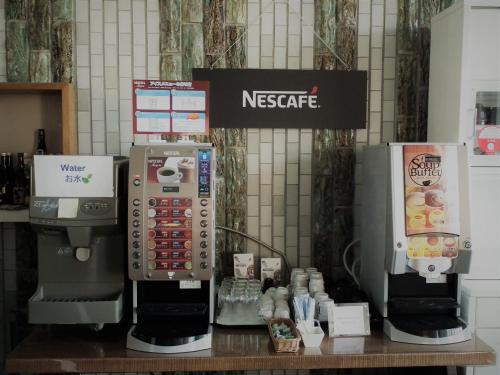 a nescafe machine and a coffee maker on a table at Granvillage Toya Daiwa Ryokan Annex in Lake Toya