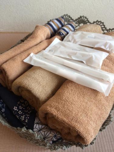 a pile of towels and chopsticks on a plate at Granvillage Toya Daiwa Ryokan Annex in Lake Toya