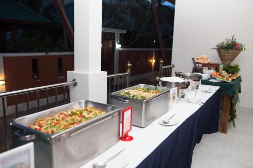 a buffet table with several trays of food at Lamai Coconut Beach Resort in Lamai