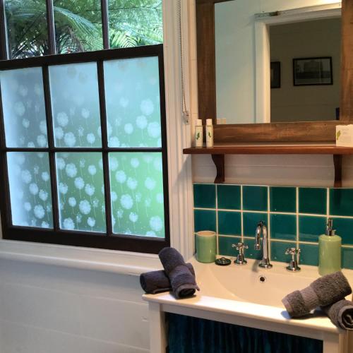 a bathroom with a sink and a window at The Old School House in Te Awamutu