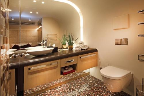 a bathroom with a sink and a toilet at Hotel Neues Tor in Bad Wimpfen