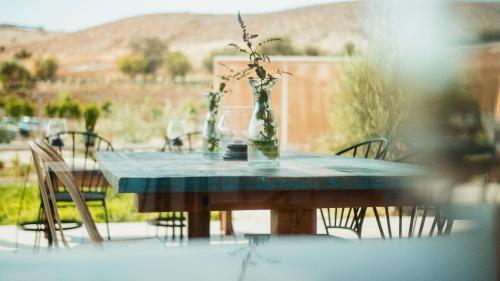 a blue table with a vase with a plant in it at Aelia Wellness Retreat in Nicosia