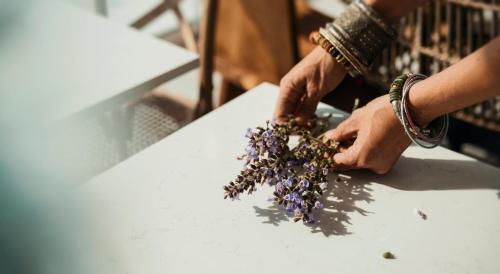 a person holding a bunch of dried flowers on a table at Aelia Wellness Retreat in Nicosia