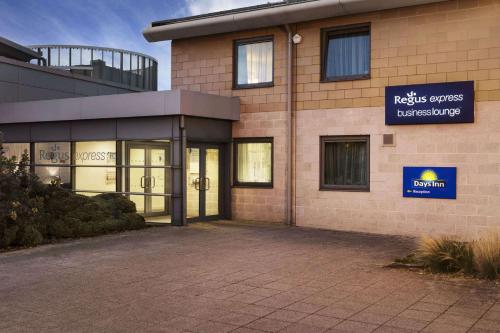 a building with a sign on the side of it at Days Inn Cannock - Norton Canes in Cannock