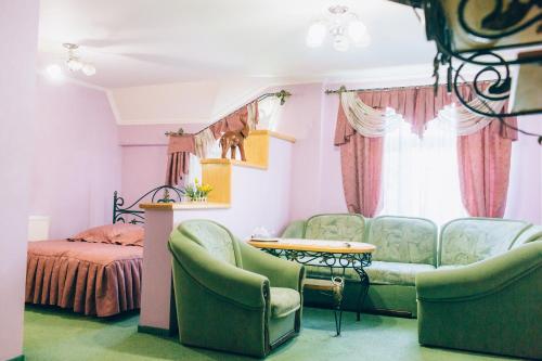a bedroom with a couch and a table and a bed at Berizka in Perechin