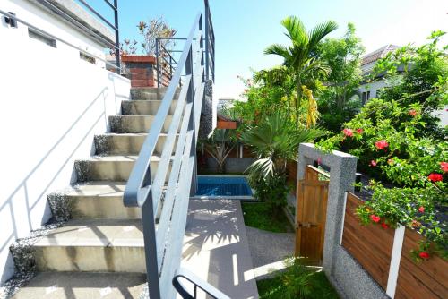 a stairway leading up to a house with a pool at Papago International Resort in Chishang