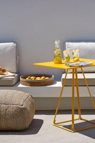 a yellow table with a tray of food on it at Nova Luxury Suites in Pirgos