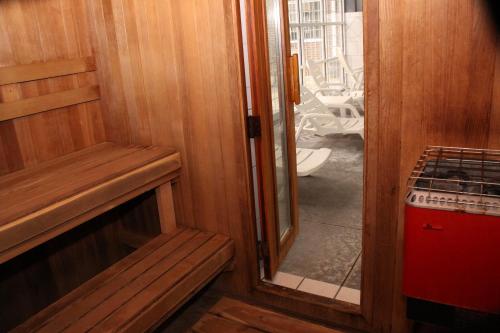 a door leading into a room with a mirror at Baymont by Wyndham Des Moines Airport in Des Moines