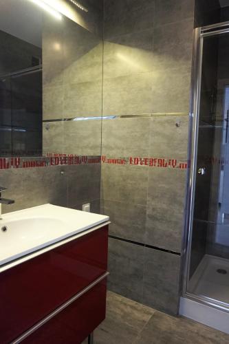 a bathroom with a sink and a shower at JTB Nautica Aparthotel in Szczecin