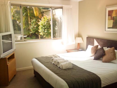 Säng eller sängar i ett rum på Beach Resort Apartment
