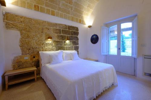 En eller flere senge i et værelse på Relais Masseria Sant'Antonio