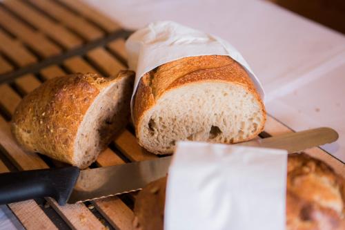 two loaves of bread sitting on a grill with a knife at Hotel Schönegg in Wengen