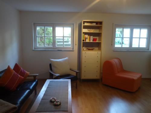 a living room with a couch and a chair at Apartement Schönbach in Holzhausen