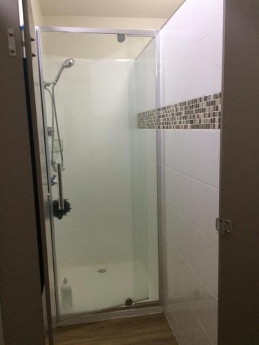 a shower with a glass door in a bathroom at Gliss Ski Club in Mount Buller
