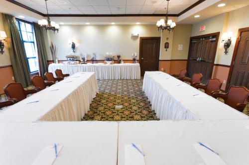 a room with rows of tables with white linens at The Appalachian at Mountain Creek in Vernon