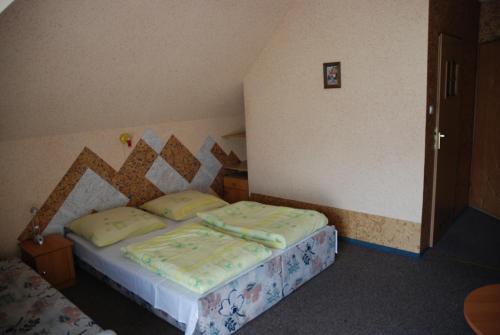 a small bedroom with a bed in a room at pensjonat kuba in Korbielów