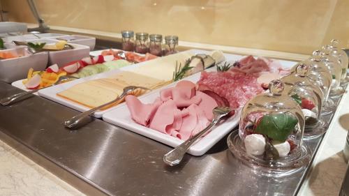 a tray of food with meat and vegetables on a table at Das Sonnenheim in Bad Kleinkirchheim