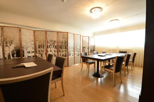 a dining room with a table and chairs at Albergo Celide in Lucca