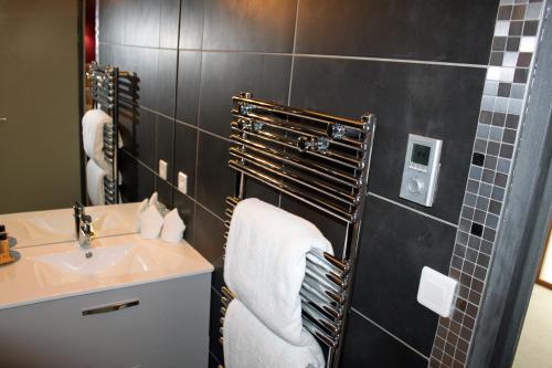 a bathroom with a sink and a towel rack at L'entre-mers in Audinghen