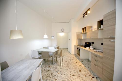 a kitchen with a table and a dining room at B&B Salernow2 in Salerno