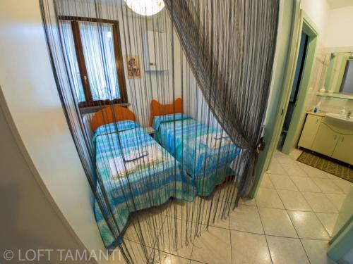 En eller flere senge i et værelse på Loft Tamanti