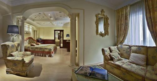 a large living room with a couch and a bed at Hotel Terme Salus in Abano Terme