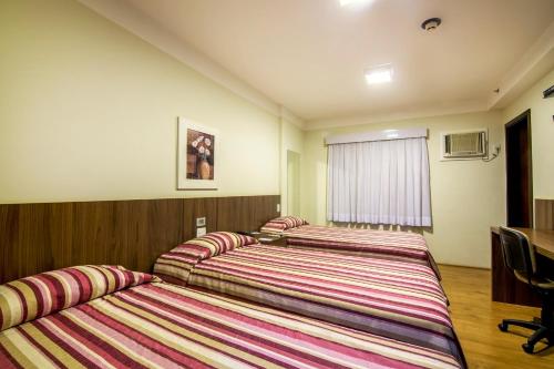 Postel nebo postele na pokoji v ubytování JR Hotel Ribeirão Preto