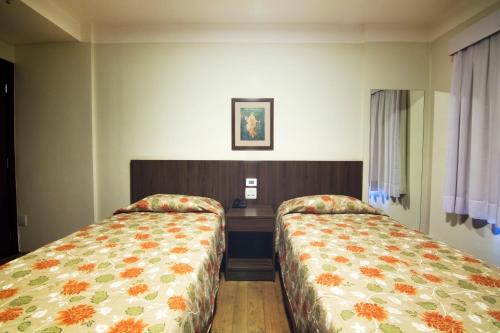 Postel nebo postele na pokoji v ubytování JR Hotel Ribeirão Preto