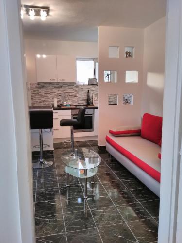 a living room with a couch and a table at Fei Fei Apartments in Račišće