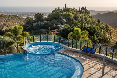 a swimming pool with a view of a mountain at Casa León Royal Retreat in Maspalomas
