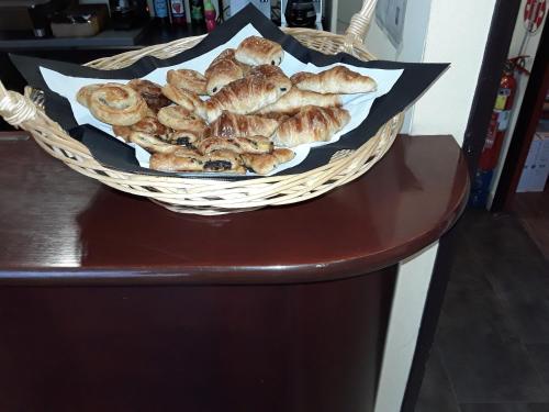 a basket of pastries sitting on a table at Hotel Dorele in Montargis
