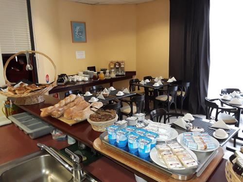 a buffet with a lot of food on a table at Hotel Dorele in Montargis
