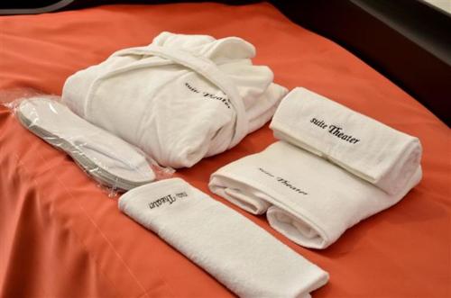 a group of white towels on a bed at Apartment Suite Theater in Split