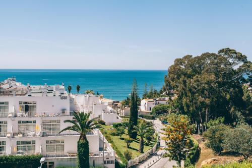 an aerial view of a white building and the ocean at Grand Muthu Forte Da Oura in Albufeira