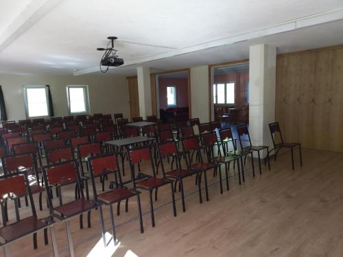 an empty room with chairs and tables in it at Grischalodge das Hotel mit Bergblick seit 1929 - schlicht, preiswert und mit einem touch Nostalgie in Parpan