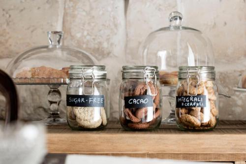 a group of glass jars filled with different types of food at Palazzo Sant'Anna Lecce in Lecce