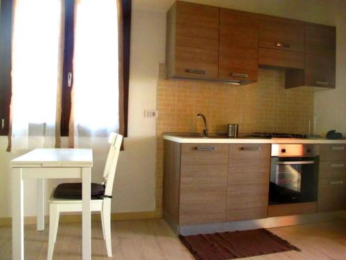 a kitchen with a white table and a white table and chair at Roccabianca in Sorso