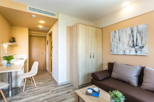 a living room with a couch and a table at Menta City Boutique Hotel in Rethymno Town