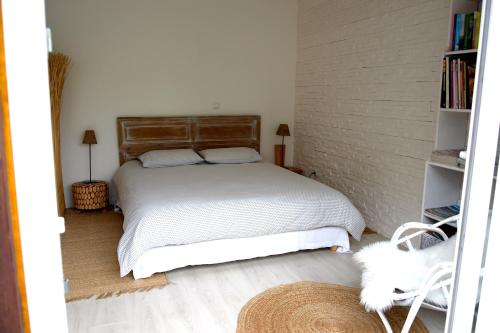 a bedroom with a bed and a book shelf at La Mazzerinière in Saint-Sylvestre