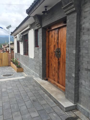 a wooden door on the side of a house at Chez Ina & Jasee in Miyun