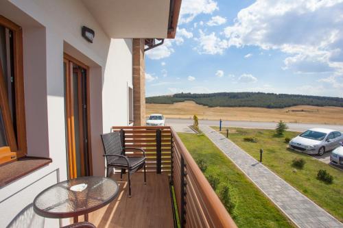 a balcony with a table and chairs and a view at Zlatibor Hills in Zlatibor