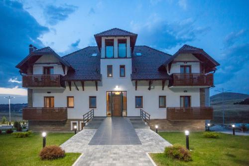 a large white house with a pathway leading to it at Zlatibor Hills in Zlatibor