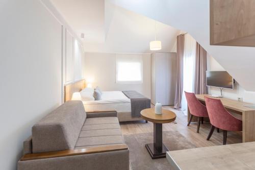 a hotel room with a bed and a couch at Zlatibor Hills in Zlatibor