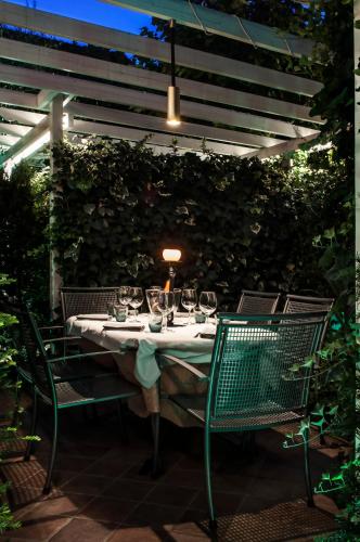 a table with wine glasses on a patio at Hotel dell'Angelo in Predore