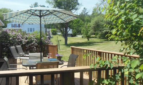 a patio with a table and an umbrella at Sugar Hill Inn in Sugar Hill