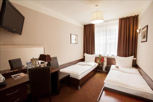 Postel nebo postele na pokoji v ubytování Hotel Diament Spodek
