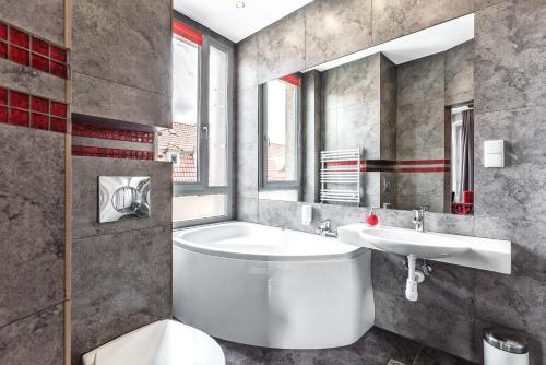 a bathroom with a white toilet and a sink at Grand Boutique Hotel - dawny Hotel Kaliski Ratuszowy in Rzepin